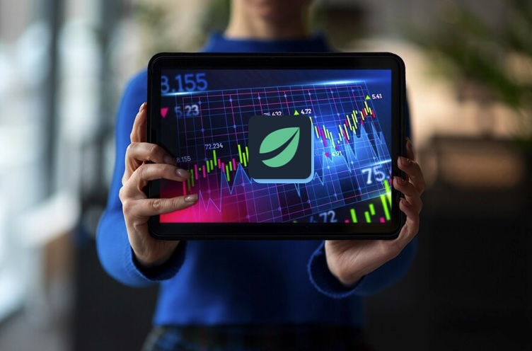 Tablet displaying Bitfinex icon and market trend