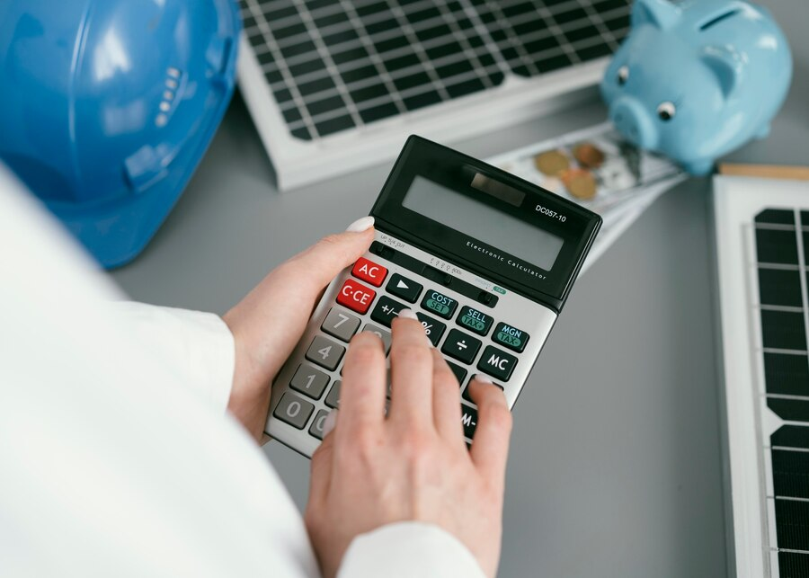 Hand holding a calculator